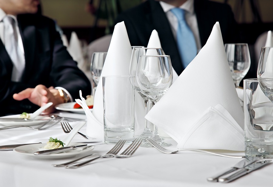 Two business people no faces over a restaurant table